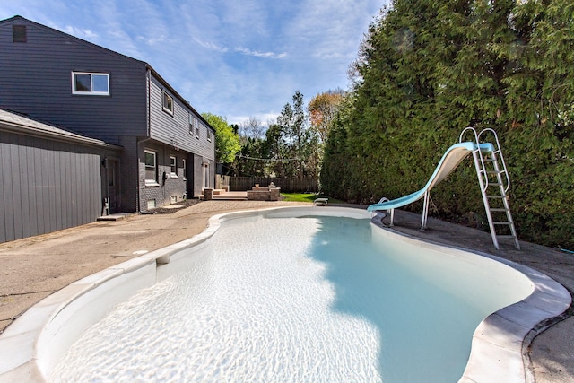 view of pool with a patio, a water slide, and a fenced in pool