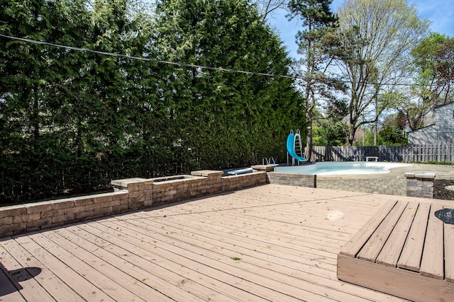 wooden terrace featuring a fenced in pool, a fenced backyard, and a hot tub