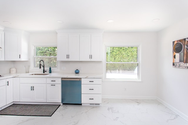 kitchen featuring white cabinets, a sink, dishwasher, marble finish floor, and baseboards