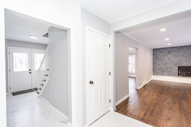 hallway with baseboards, recessed lighting, marble finish floor, and stairway