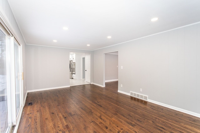 empty room featuring visible vents, recessed lighting, dark wood finished floors, and baseboards