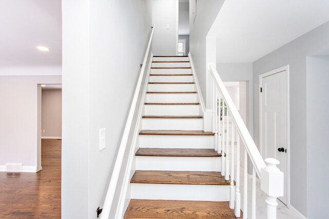 stairs with baseboards, recessed lighting, and wood finished floors