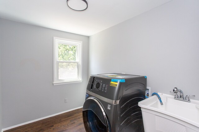 washroom with laundry area, a sink, dark wood finished floors, washer / clothes dryer, and baseboards