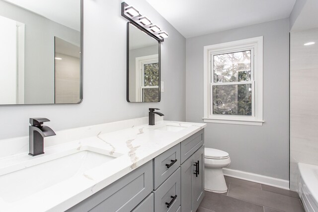 full bathroom with toilet, a wealth of natural light, and a sink
