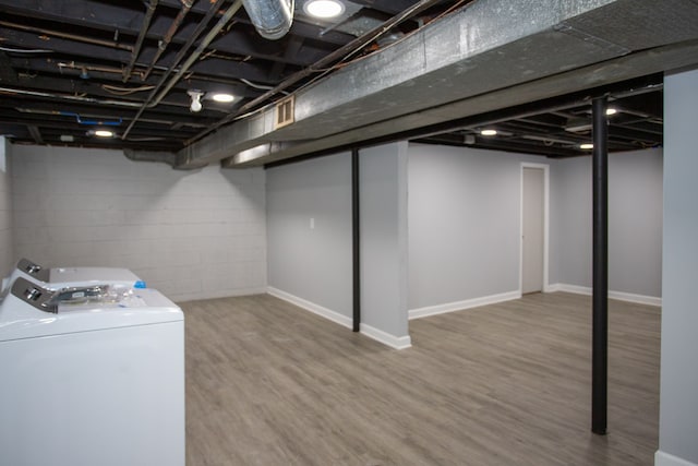 finished basement with washer and dryer, baseboards, and wood finished floors