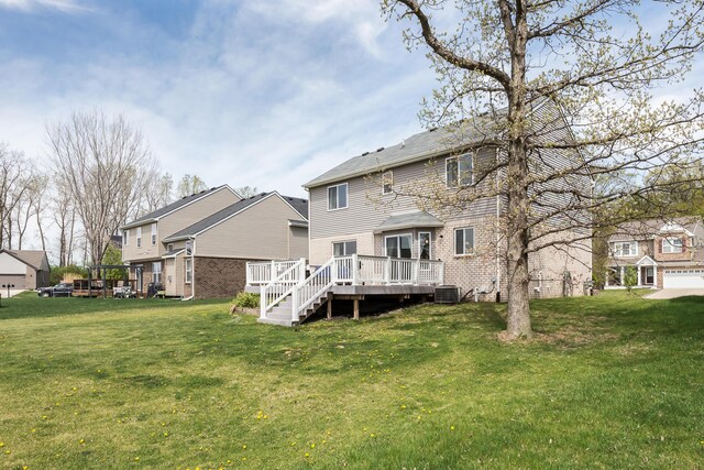 rear view of house featuring a residential view, a yard, cooling unit, and a deck