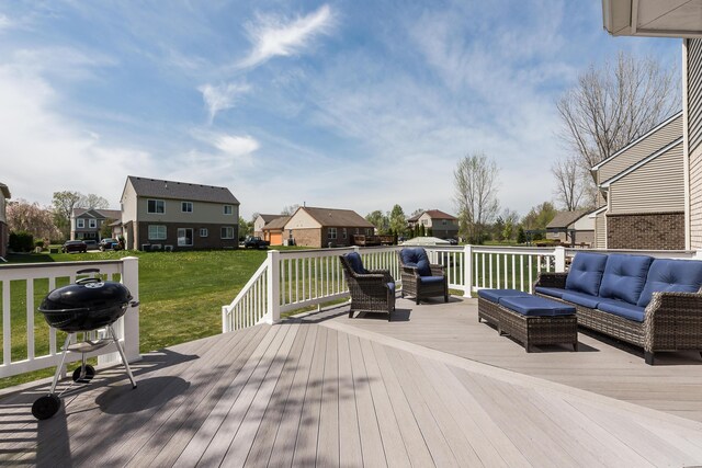deck with grilling area, a lawn, outdoor lounge area, and a residential view