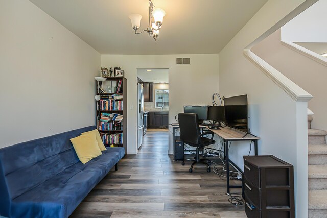 home office with visible vents, dark wood finished floors, and an inviting chandelier