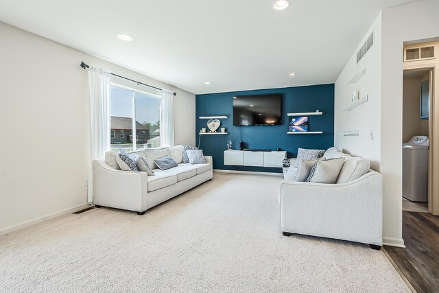 living room with visible vents, recessed lighting, and washer / dryer
