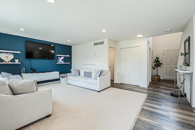 living area with recessed lighting, visible vents, and wood finished floors
