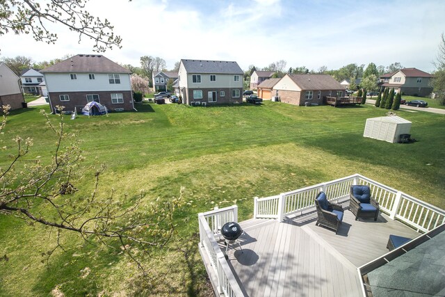 view of yard featuring a residential view and a deck