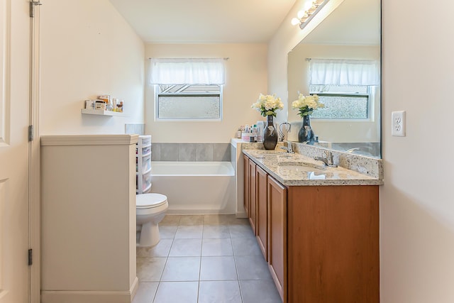 bathroom featuring tile patterned flooring, a bath, toilet, and vanity