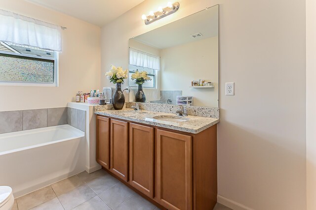 bathroom with a sink, tile patterned flooring, double vanity, visible vents, and a bath