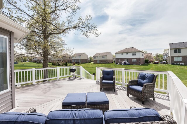 deck with a yard and a residential view