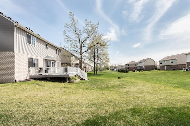 view of yard with a wooden deck and a residential view