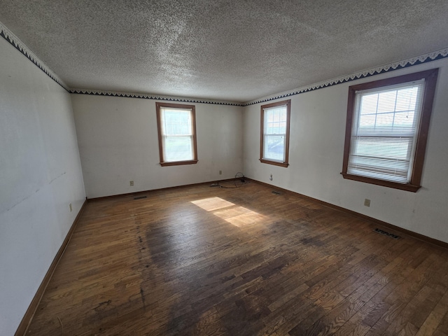4391 Tamarack Rd, Hillsdale, MI 49242 - spare room with a textured ceiling, baseboards, hardwood / wood-style floors, and visible vents