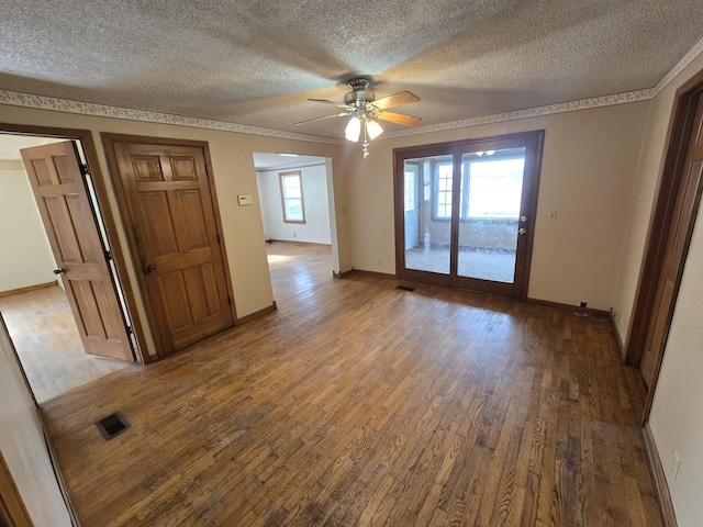 4391 Tamarack Rd, Hillsdale, MI 49242 - spare room with wood finished floors, a textured ceiling, visible vents, ceiling fan, and baseboards