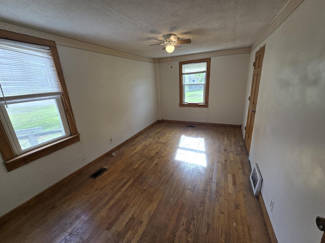 4391 Tamarack Rd, Hillsdale, MI 49242 - empty room featuring ceiling fan, a textured ceiling, visible vents, and wood finished floors