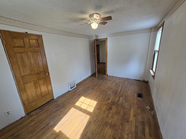 4391 Tamarack Rd, Hillsdale, MI 49242 - unfurnished bedroom featuring a textured ceiling, visible vents, and wood-type flooring