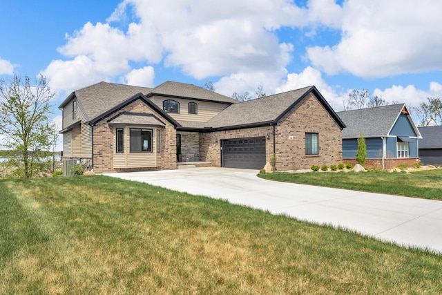 146 Bloomfield Blvd, Brooklyn, MI 49230 - craftsman-style house featuring a garage, concrete driveway, a front yard, and brick siding