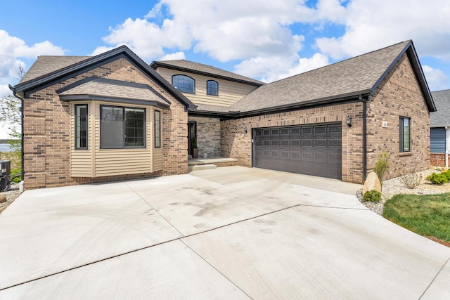 146 Bloomfield Blvd, Brooklyn, MI 49230 - french country home featuring brick siding, an attached garage, roof with shingles, and concrete driveway