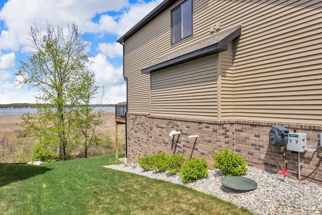 146 Bloomfield Blvd, Brooklyn, MI 49230 - view of side of property with brick siding, a water view, and a yard