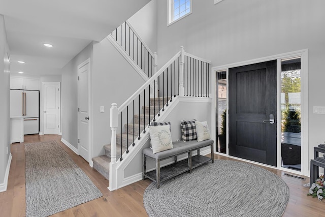 146 Bloomfield Blvd, Brooklyn, MI 49230 - entrance foyer featuring visible vents, wood finished floors, a wealth of natural light, and stairway