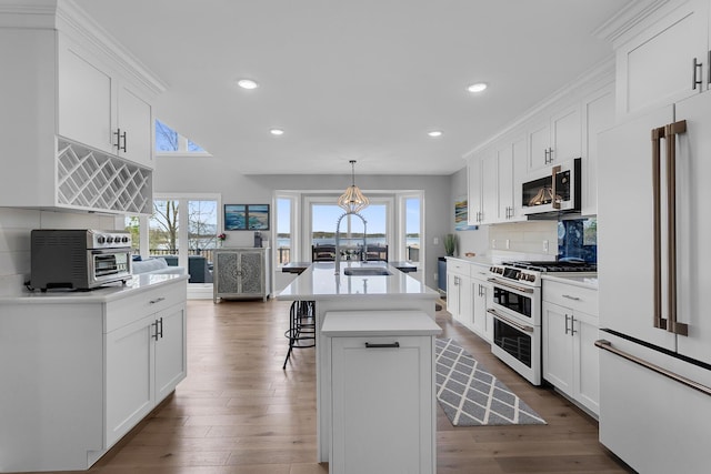 146 Bloomfield Blvd, Brooklyn, MI 49230 - kitchen with a breakfast bar area, white cabinetry, high end appliances, and a toaster