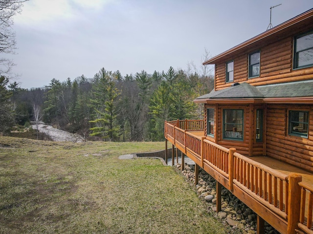 view of yard with a view of trees and a wooden deck
