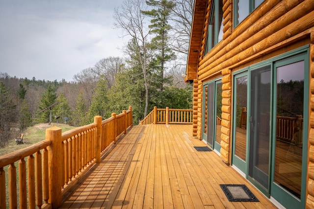 wooden deck with a wooded view