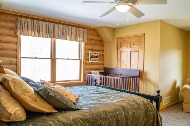 bedroom featuring visible vents, carpet flooring, baseboards, and rustic walls
