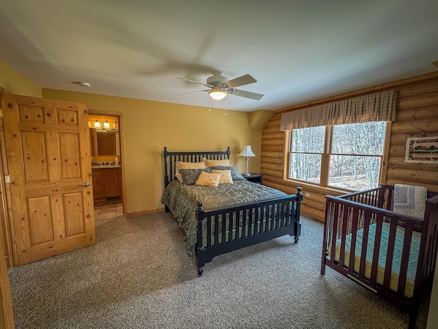 bedroom featuring baseboards, ceiling fan, rustic walls, and carpet flooring