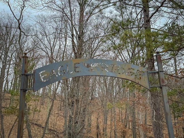 view of gate with a wooded view