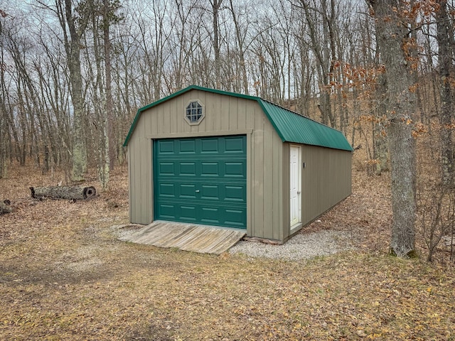 detached garage featuring a shed