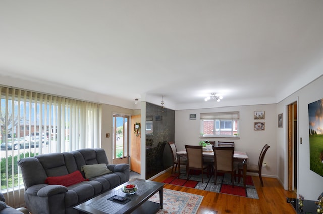 living area featuring baseboards and wood finished floors