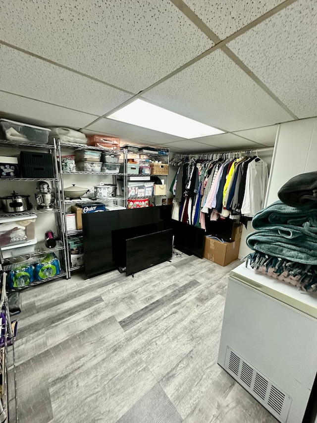spacious closet with a paneled ceiling
