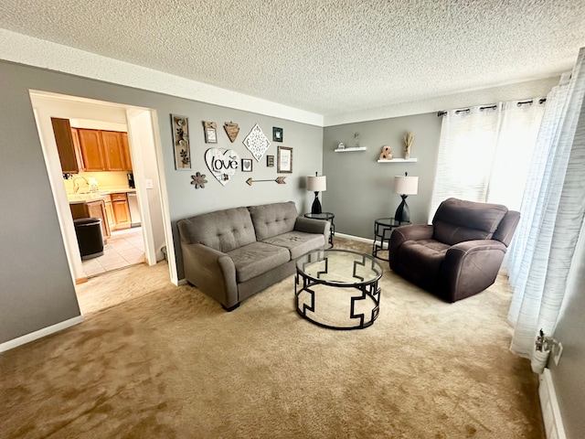 living room featuring baseboards, light carpet, and a textured ceiling