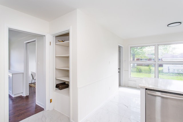 hall featuring baseboards and marble finish floor