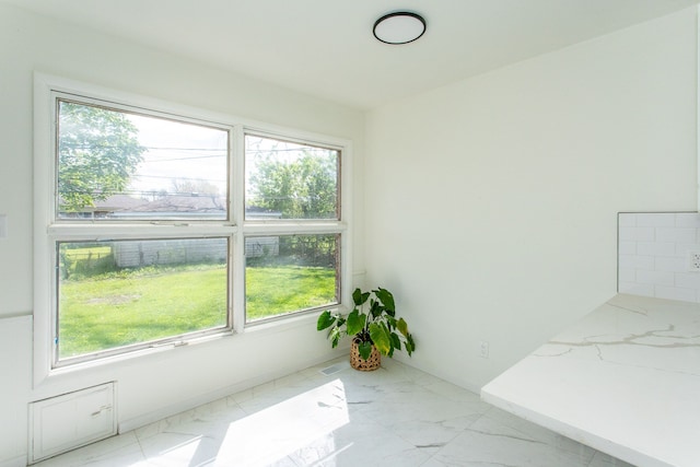 interior space featuring marble finish floor