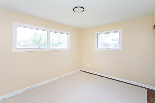 empty room featuring baseboards and a healthy amount of sunlight