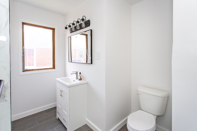 full bathroom featuring vanity, baseboards, tile patterned floors, and toilet