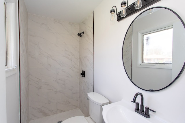 bathroom featuring a sink, a stall shower, and toilet