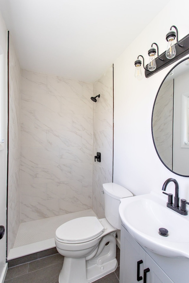 full bath featuring vanity, toilet, tile patterned flooring, and a stall shower