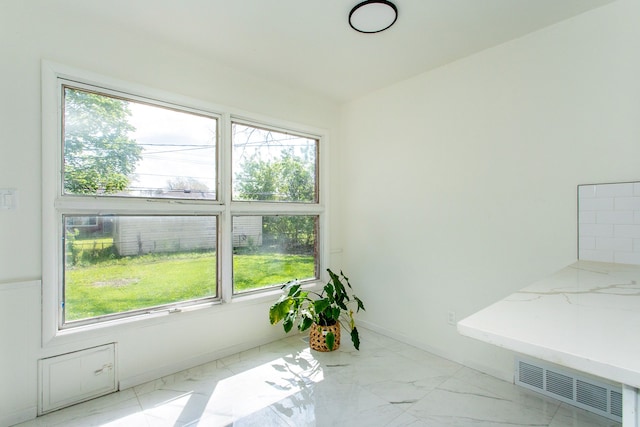 interior space with visible vents, marble finish floor, and a wealth of natural light