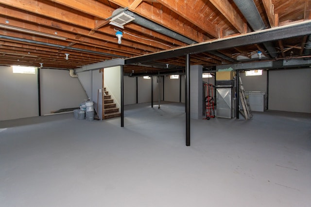 basement with visible vents, washer / dryer, and stairway