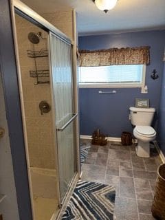 10100 Woodlawn Rd, Saint Helen, MI 48656 - bathroom featuring a stall shower, baseboards, and toilet
