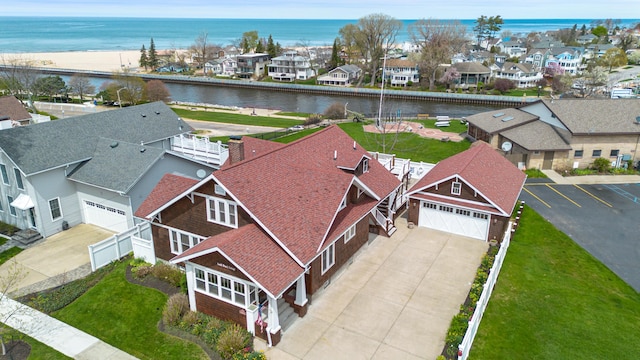 drone / aerial view with a water view and a residential view