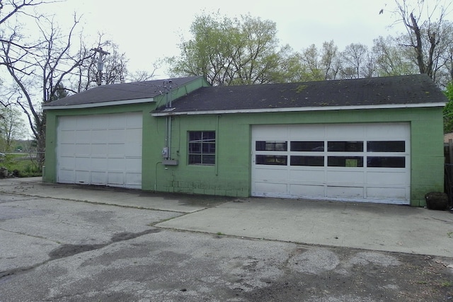 garage featuring concrete driveway