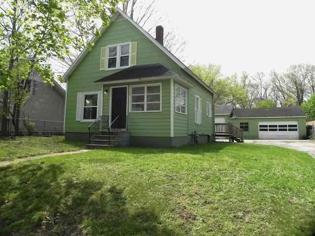 view of front of home with a detached garage, fence, a chimney, and a front lawn