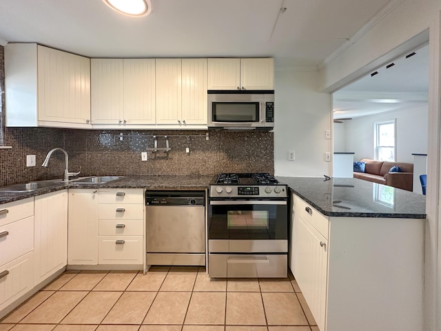 524 E Farnum Ave, Royal Oak, MI 48067 - kitchen featuring stainless steel appliances, light tile patterned floors, a sink, and tasteful backsplash